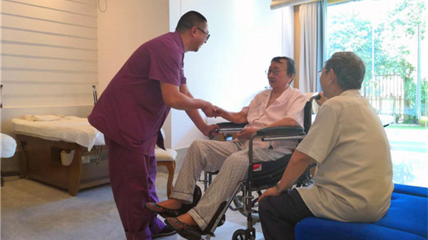 一暄康养成都中医理疗中心理疗师在给院内老人治疗前交流