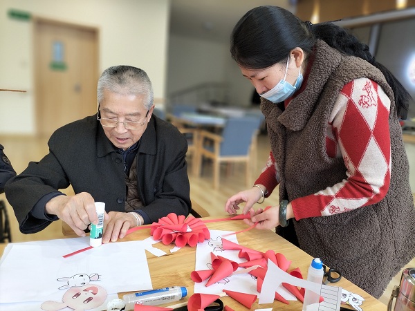 成都医养一体养老院一暄康养和煦元组织长者一起折纸度兔年